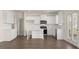 Stylish kitchen features white cabinets, island, and a view to the backyard at 1069 Blue Juniper Cir, Loganville, GA 30052