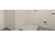 This is an unfinished laundry room with vinyl flooring and a utility sink at 1069 Blue Juniper Cir, Loganville, GA 30052