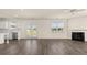 Open-concept living room and kitchen with hardwood floors and a modern fireplace at 1069 Blue Juniper Cir, Loganville, GA 30052
