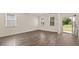 Sunlit living room features hardwood floors and views of the front yard at 1069 Blue Juniper Cir, Loganville, GA 30052