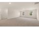 Large living room with neutral carpet, recessed lighting, and natural light from windows at 1069 Blue Juniper Cir, Loganville, GA 30052