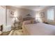 Bright bedroom features a tufted headboard and accent lamps at 300 Johnson Ferry Ne Rd # A403, Atlanta, GA 30328