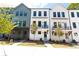 Row of modern townhomes featuring varied colors, small balconies, and well-kept lawns at 507 Zeal Street # 334, Atlanta, GA 30315