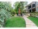 Serene backyard with a stone pathway leading to lounge chairs near the pool at 8760 Colonial Pl, Duluth, GA 30097
