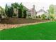 Expansive backyard with retaining wall and mature landscaping creating a private oasis at 8760 Colonial Pl, Duluth, GA 30097
