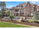 Luxury home backyard featuring a beautiful pool with stone accents and lush landscaping at 8760 Colonial Pl, Duluth, GA 30097