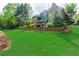 Spacious backyard featuring a lush lawn, mature trees, and well-maintained landscaping at 8760 Colonial Pl, Duluth, GA 30097