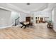 Finished basement area featuring hardwood floors, a foosball table, and open access to a bar area at 8760 Colonial Pl, Duluth, GA 30097