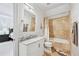 Bathroom with marble countertops, tub-shower, and tan tiling at 8760 Colonial Pl, Duluth, GA 30097