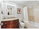 Well lit bathroom featuring a granite vanity and tub-shower combination at 8760 Colonial Pl, Duluth, GA 30097