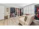 Organized walk-in closet with custom shelving and ample storage space for clothes, shoes and accessories at 8760 Colonial Pl, Duluth, GA 30097