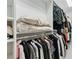 Neatly organized walk-in closet with hanging rods and storage shelves at 8760 Colonial Pl, Duluth, GA 30097