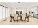 Elegant dining room with a modern chandelier, stylish chairs, and ample natural light at 8760 Colonial Pl, Duluth, GA 30097