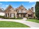 Beautiful brick and stone home with manicured lawn and inviting curb appeal at 8760 Colonial Pl, Duluth, GA 30097