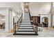 Grand foyer with soaring ceilings, elegant staircase, marble floors, and view to formal dining area at 8760 Colonial Pl, Duluth, GA 30097