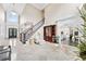 Grand foyer features a beautiful staircase, soaring ceilings, and views into the gourmet kitchen at 8760 Colonial Pl, Duluth, GA 30097