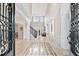 Grand foyer with high ceilings, marble floors, and elegant staircase at 8760 Colonial Pl, Duluth, GA 30097