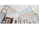 Soaring ceilings and natural light flood this great room with an elegant chandelier and access to the second floor at 8760 Colonial Pl, Duluth, GA 30097