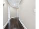 Elegant hallway with dark hardwood floors, crown molding, and curved architectural details at 8760 Colonial Pl, Duluth, GA 30097
