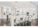 Gourmet kitchen features stainless steel appliances, a large center island with bar seating, and custom white cabinetry at 8760 Colonial Pl, Duluth, GA 30097