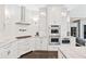 Gourmet kitchen features stainless steel appliances, custom cabinetry and a white backsplash with beautiful countertops at 8760 Colonial Pl, Duluth, GA 30097