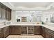 Gourmet kitchen featuring stainless steel appliances, a wine fridge, and an open view to living spaces at 8760 Colonial Pl, Duluth, GA 30097