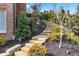 Landscaped stone steps leading to backyard with lush greenery and mulched flower beds at 8760 Colonial Pl, Duluth, GA 30097