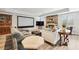Spacious living room featuring a fireplace, large screen and comfortable seating, perfect for entertaining guests at 8760 Colonial Pl, Duluth, GA 30097