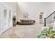 Open floorplan living room featuring travertine floors, tall ceilings, and French doors for an abundance of light at 8760 Colonial Pl, Duluth, GA 30097