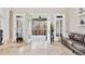 Sophisticated living room with access to an outdoor porch features a designer sofa and lots of natural light at 8760 Colonial Pl, Duluth, GA 30097