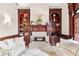 Comfortable living room featuring a fireplace, built-in bookshelves, and neutral decor at 8760 Colonial Pl, Duluth, GA 30097