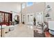 Bright living room boasts tall ceilings, travertine floors, and large windows with access to the outdoor living space at 8760 Colonial Pl, Duluth, GA 30097