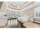 Spacious main bedroom with tray ceiling, bay window, hardwood floors and luxury furnishing at 8760 Colonial Pl, Duluth, GA 30097