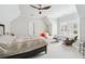 Bright bedroom with a ceiling fan, sitting area, and large windows with shutters at 8760 Colonial Pl, Duluth, GA 30097