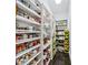 Spacious walk-in pantry with custom shelving for optimal storage at 8760 Colonial Pl, Duluth, GA 30097