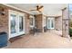 Covered brick patio with ceiling fan, stone flooring, and outdoor seating area at 8760 Colonial Pl, Duluth, GA 30097