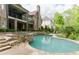 An inground pool surrounded by lush landscaping and a patio area, perfect for outdoor relaxation at 8760 Colonial Pl, Duluth, GA 30097