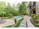 Beautiful backyard with an inground pool, stone patio, and lush landscaping, perfect for relaxation at 8760 Colonial Pl, Duluth, GA 30097