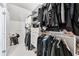 Walk-in closet with custom shelving and racks for efficient clothing organization at 8760 Colonial Pl, Duluth, GA 30097