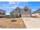 Charming two-story home with a well-maintained lawn and a two-car garage at 1109 Alaska St, Hampton, GA 30228