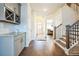 Inviting hallway with hardwood floors and a view of the staircase and dining area at 1109 Alaska St, Hampton, GA 30228