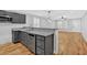 Kitchen featuring gray cabinets, stainless steel dishwasher, granite countertops, and wooden floors at 172 4Th St, Emerson, GA 30137