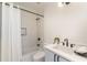 Bright bathroom featuring a shower-tub combo, white subway tile, and modern vanity with black hardware at 816 Berne St # 4, Atlanta, GA 30316