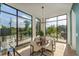 Elegant dining area with natural light from expansive windows and modern chandelier at 816 Berne St # 4, Atlanta, GA 30316