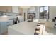A modern kitchen showcases a long island with seating, mixed cabinetry, stainless appliances, and natural light at 816 Berne St # 4, Atlanta, GA 30316