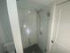 A glass shower enclosure boasts stylish tile and modern fixtures in this bathroom at 145 Amherst Nw Pl, Atlanta, GA 30327