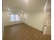 Clean bedroom with wood-look floors, a window, and a double-door closet at 145 Amherst Nw Pl, Atlanta, GA 30327