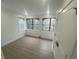 Bright bedroom with modern flooring, trim, and large arched windows overlooking wooded area at 145 Amherst Nw Pl, Atlanta, GA 30327