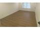 A well-lit bedroom features modern flooring and a single window for natural light at 145 Amherst Nw Pl, Atlanta, GA 30327