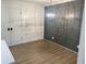 Dining room featuring paneled walls, modern lighting, and new floors at 145 Amherst Nw Pl, Atlanta, GA 30327